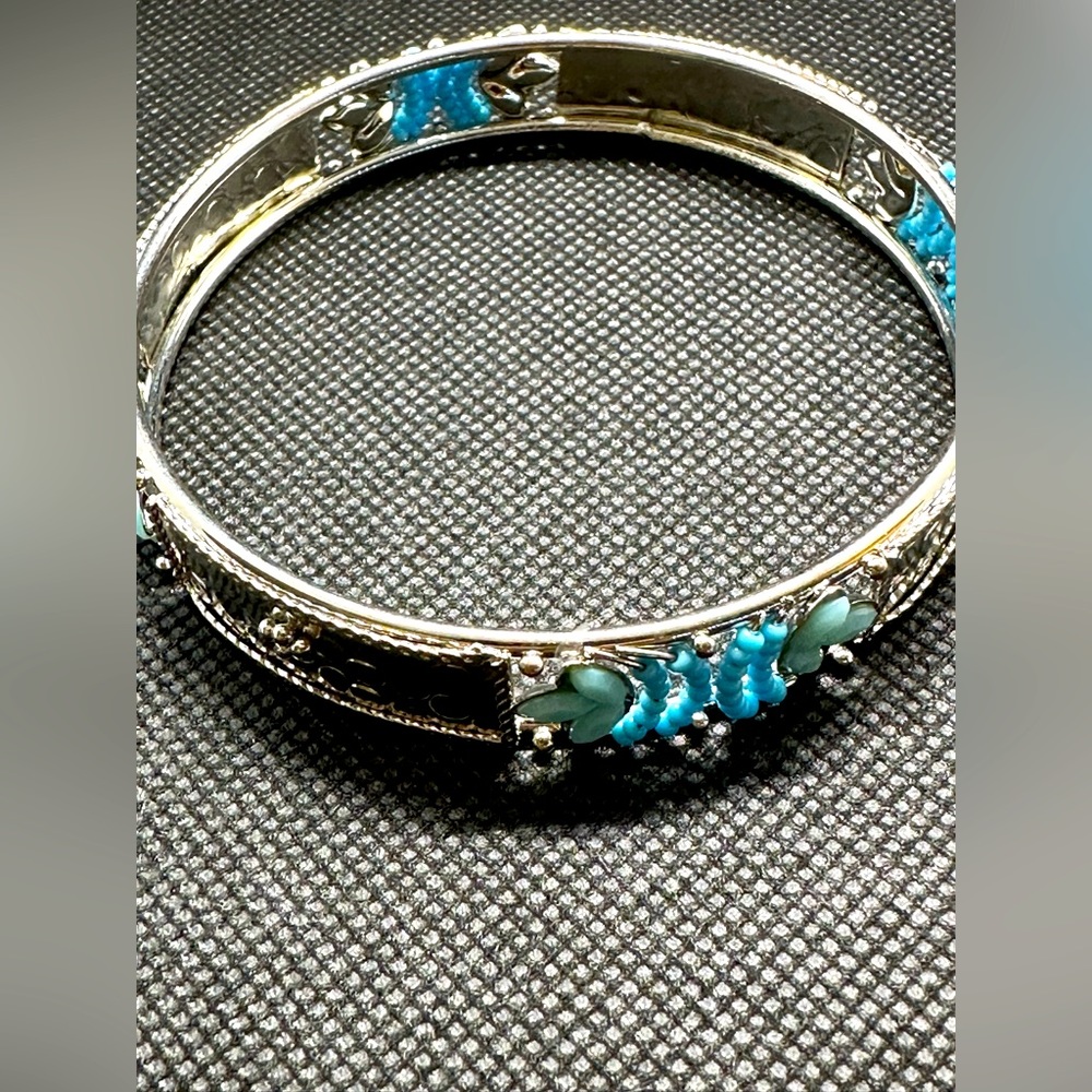 Beautiful silver toned bracelet with blue stone embellishments.
